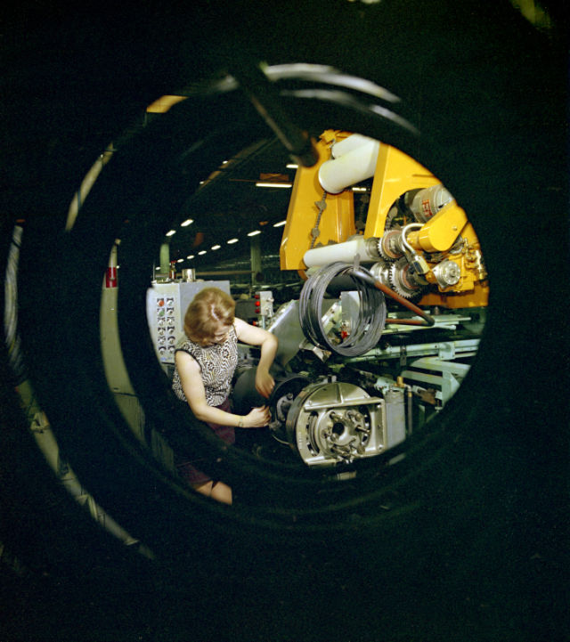 Tyre assembly using an assembly machine. Shoulder cables waiting on the side.